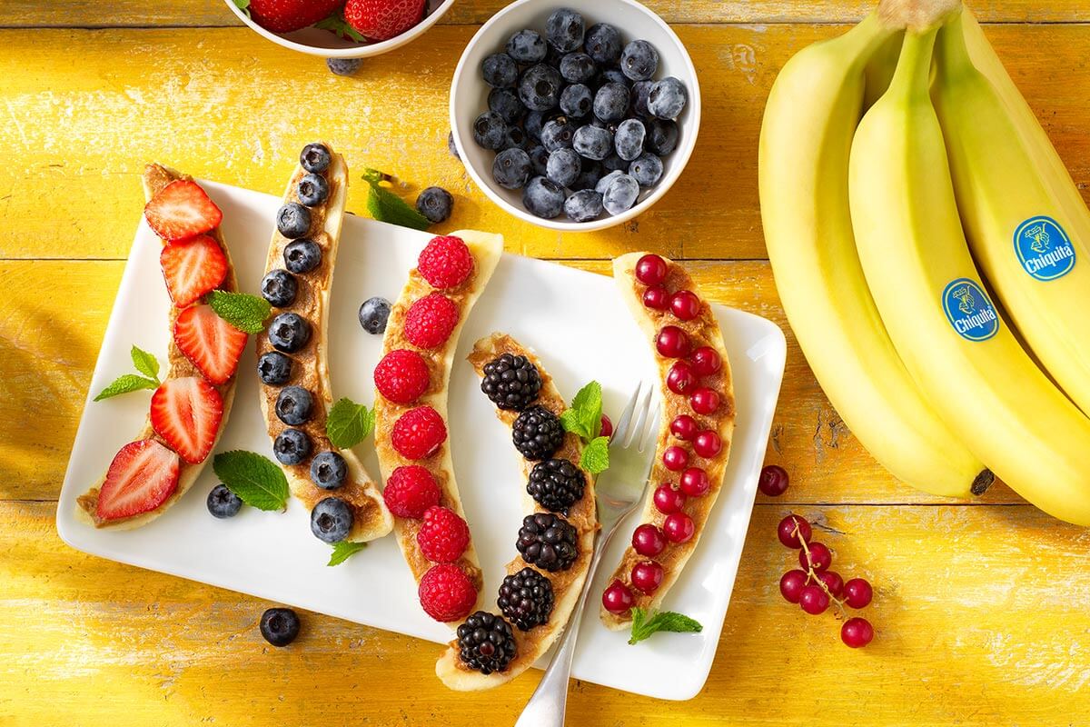 Chiquita banana split healthy breakfast with red fruits and peanut butter