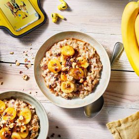 Warm porridge with baked banana, cacao nibs and hazelnut